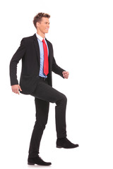 Businessman climbing virtual ladder