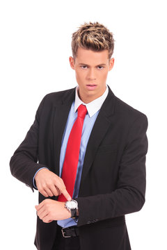 Businessman impatiently pointing to his watc