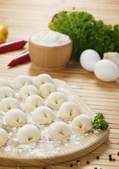Fototapeta na wymiar Meat dumplings on the kitchen board