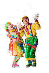 Two cheerful clowns  in the soap bubbles