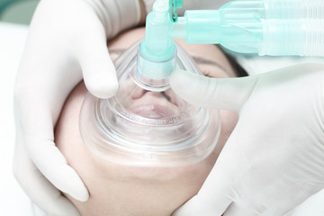 Breathing mask to the patient's face. Phase of resuscitation.