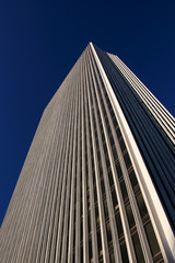 Obraz premium Office Tower rising into the Deep Blue Sky Facing Left