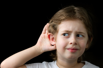 Fototapeta premium Boy listening with hand on an ear
