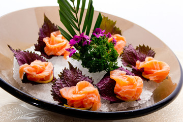 An assortment of different types of sashimi served on a delicate