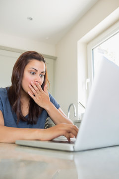 Surprised woman using the laptop