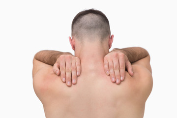 Naklejka premium Rear view of shirtless man with shoulder pain