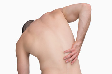 Naklejka premium Rear view of shirtless man with back pain