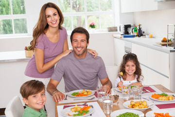 Family smiling at the dinner table