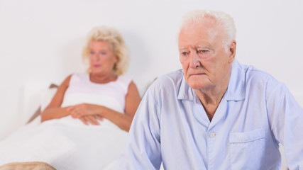 Unsmiling aged couple