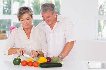 Old couple preparing vegetables