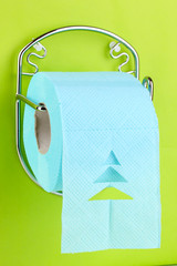 Roll of toilet paper on  holder fixed to wall