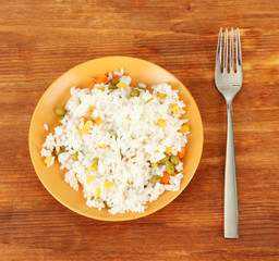 Risotto on color plate on wooden background