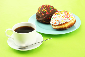 Tasty donuts on color plate on color background