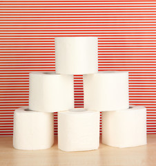 Rolls of toilet paper on striped red background