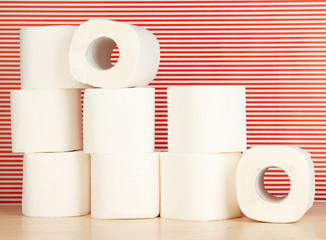 Rolls of toilet paper on striped red background
