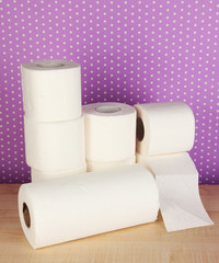 Rolls of toilet paper on purple with dots background