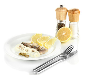 Dish of herring and lemon on plate isolated on white