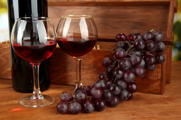composition of wine,box and grapes on bright background