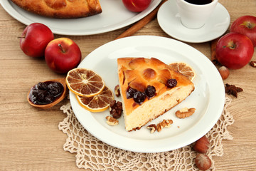 slice of tasty homemade pie with jam and apples and cup of