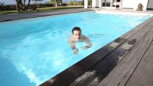 Man swimming in private swimming-pool