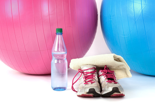 Exercise balls with sneakers and a water bottle