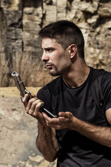 menacing man reloading a handgun