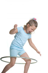 Adorable blond girl having fun in the studio with a hula hoop