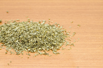 Fototapeta na wymiar Pile of dried parsley on wooden worktop