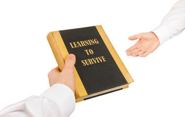 Businessman giving an used book to another businessman