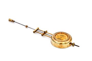 Brass pendulum of old clock isolated on white background