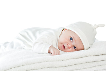 Blue eyes baby boy on white towels