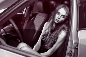 beautiful sexy fashion girl model with makeup sitting in car