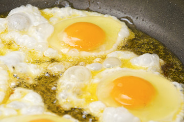 Fried eggs on a frying pan