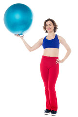 Fototapeta na wymiar Lady gym instructor holding pilates ball