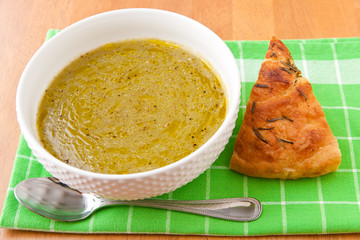 Broccoli and  potato cream soup garnished with olive oil and bl