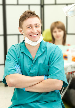 young happy dentist in his surgery