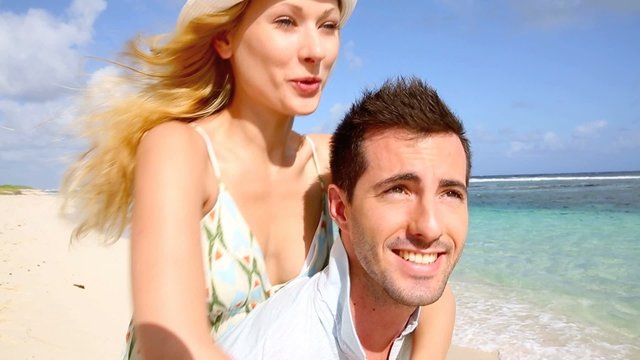 Cheerful couple enjoying vacation at the beach