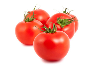Five ripe tomatoes on white background