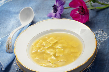 warm broth with ravioli