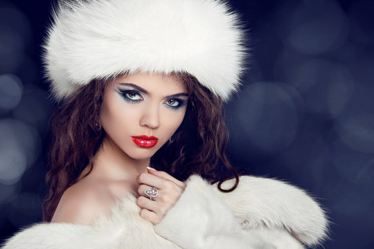 Winter woman in fur coat. Glamour portrait of beautiful woman mo