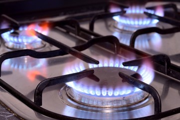 Closeup shot of the fire on gas kitchen stove burner. Closeup of burner or cooker with flame. Stove...