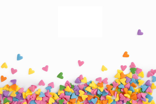 Colorful hearts confetti on white, horizontal