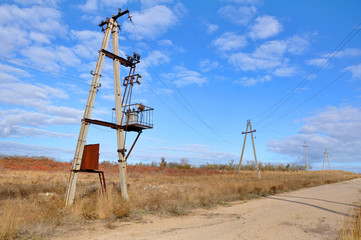 Old transformer and power line on a rural road