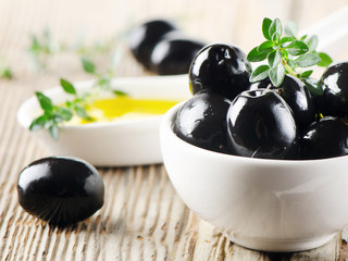 Black olives on a wooden table