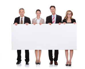 Businesspeople holding a blank banner