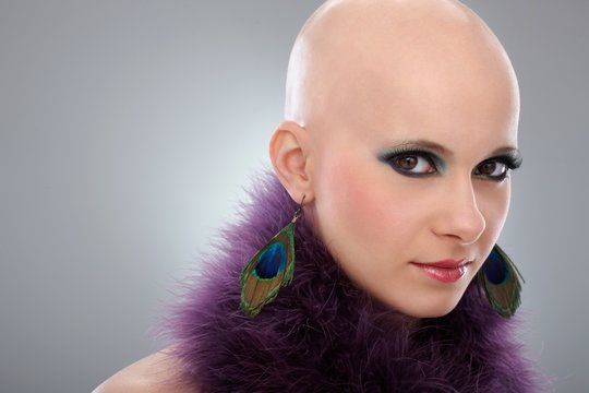 Portrait of bald woman in purple boa