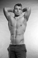 Fototapeta premium Muscled fitness man. Black and white studio shot.