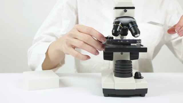 Scientist with microscope