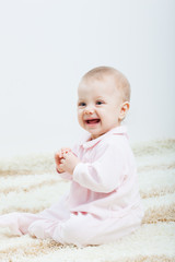 baby girl sitting on the carpet