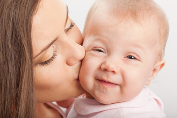 mother  kissing baby girl